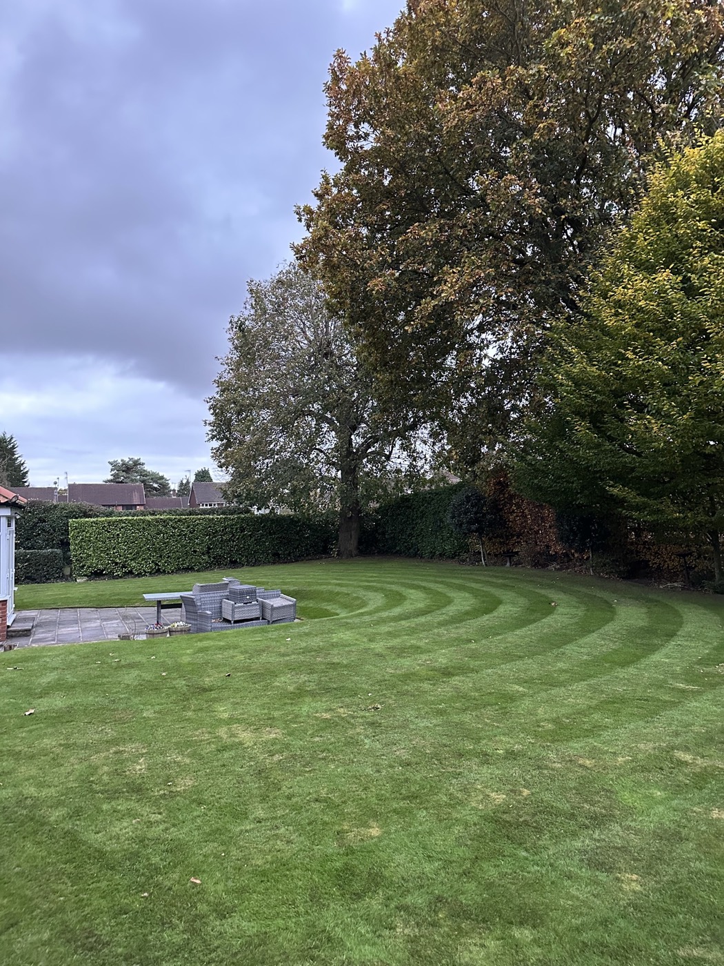 A large lawn mown with clean curved stripes
