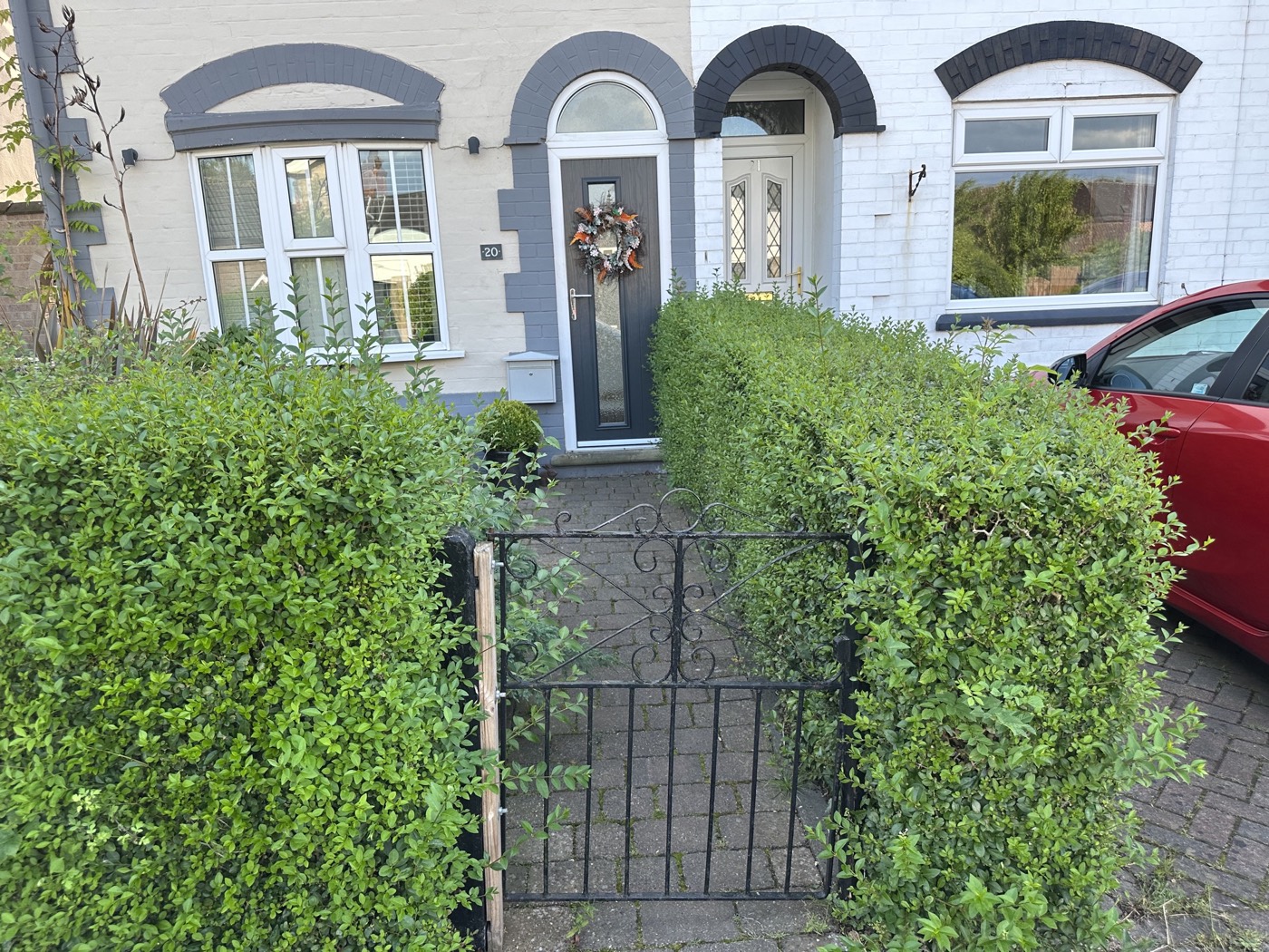 Before — Front garden hedge before and after being cut back and shaped