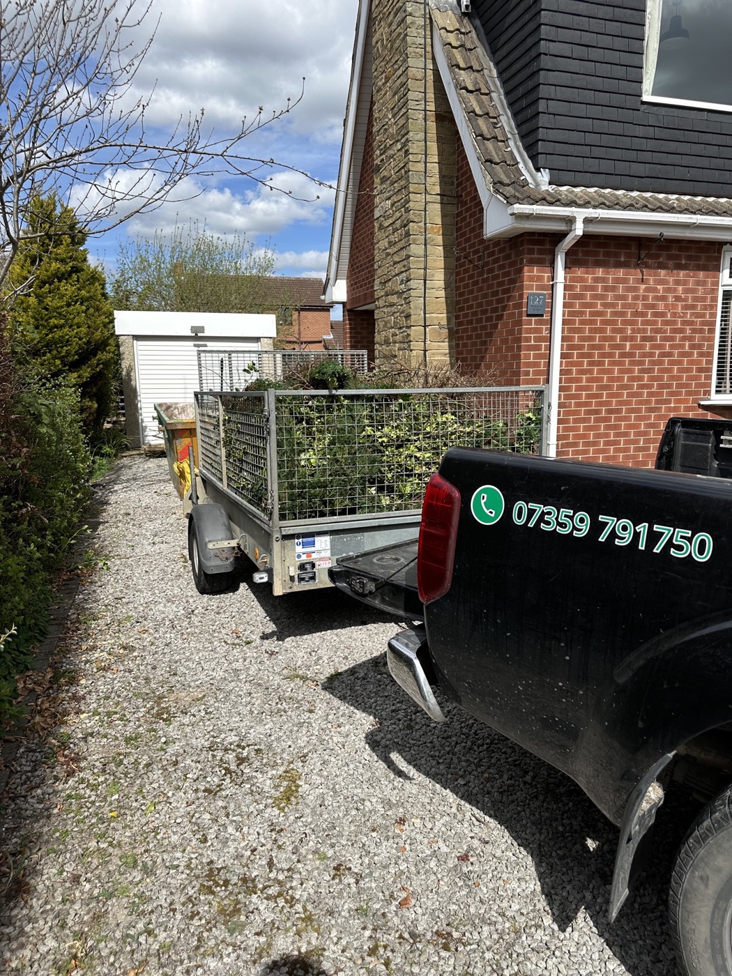 Green waste loaded onto a trailer ready to be taken away